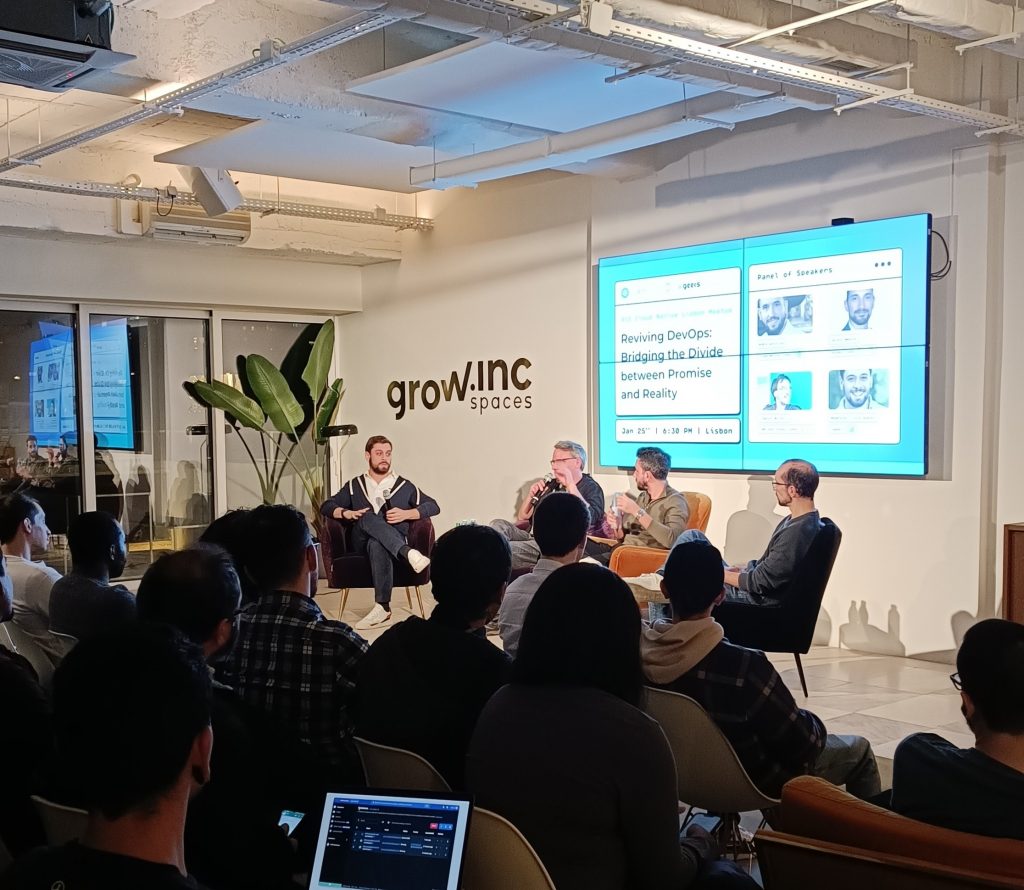 A Photo of Four men presenting something in front of an audience.