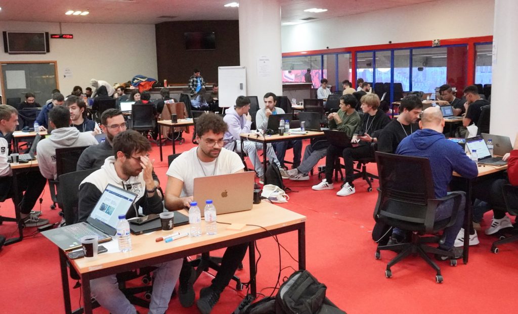A photo of small groups working on laptops.